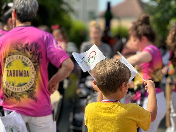 Enfant tenant le drapeau des Jeux Olympiques